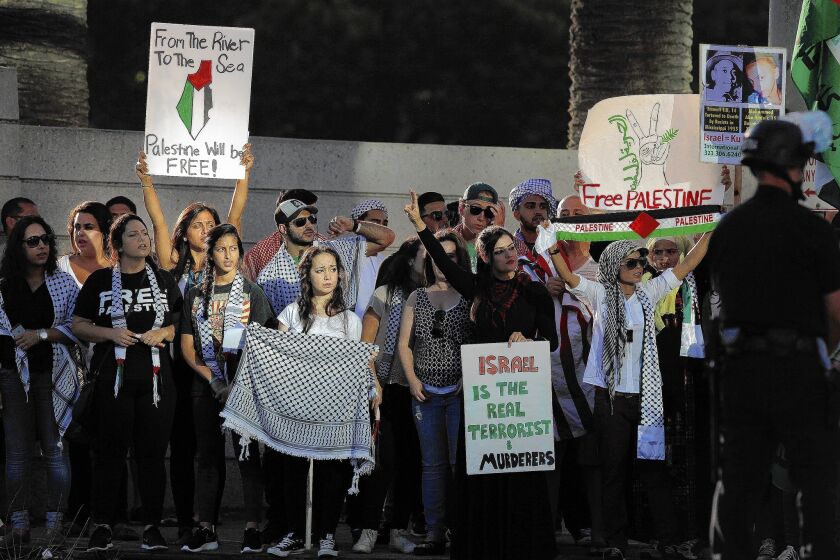 Pro-Palestinian protesters, above, and supporters of Israel descended on a federal building in Westwood on Sunday, reflecting rising tensions over Israeli-Palestinian unrest.