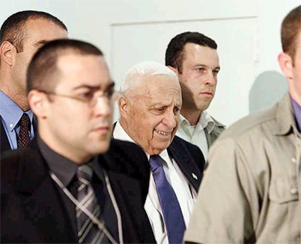 Israeli Prime Minister Ariel Sharon, center, arrives in the Knesset, the Israeli parliament, on Tuesday. The Knesset is slated to vote on Sharon's plan to withdraw Israeli settlements from the Gaza Strip.