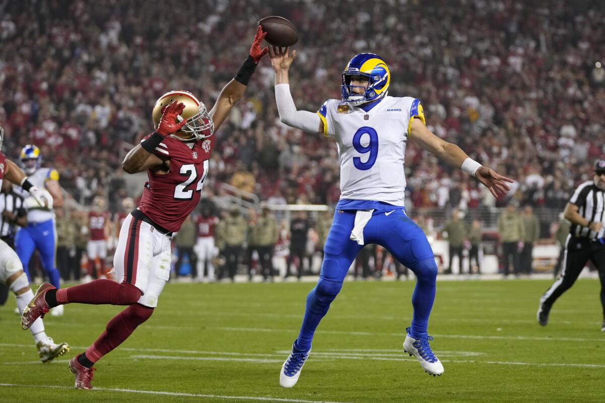 Rams quarterback Matthew Stafford (9) passes as San Francisco 49ers defensive back K'Waun Williams (24) applies pressure.