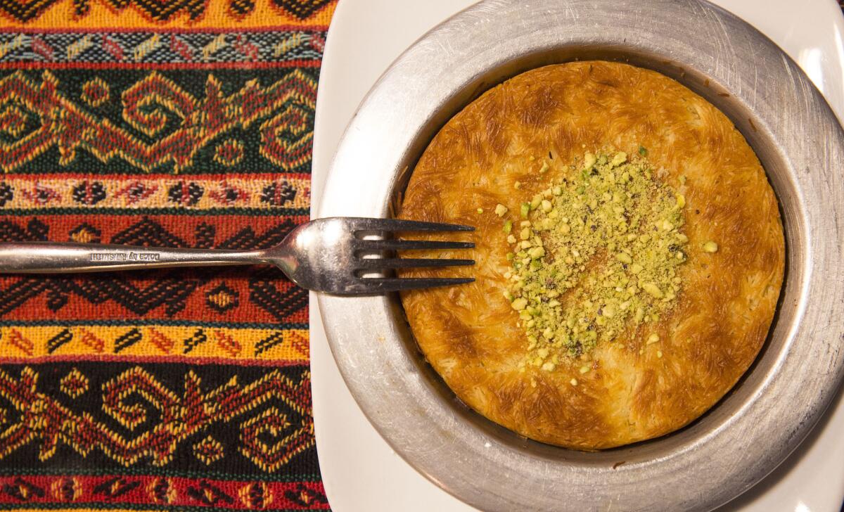 Kunefe, a desert of shredded filo dough stuffed with Kurdish cheese and topped with pistachios and homemade syrup at Niroj.