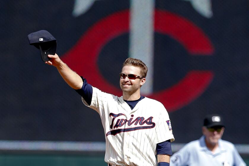 Minnesota Twins second baseman Brian Dozier acknowledges the standing ovation by fans after it was announced during the baseball game against the Detroit Tigers that he was named to the American League All-Star team.