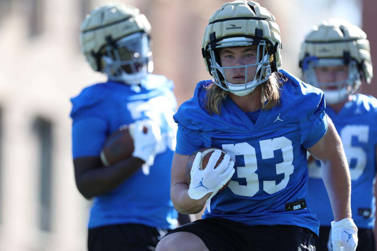 UCLA running back Carson Steele carries the football during 2023 spring football practice.