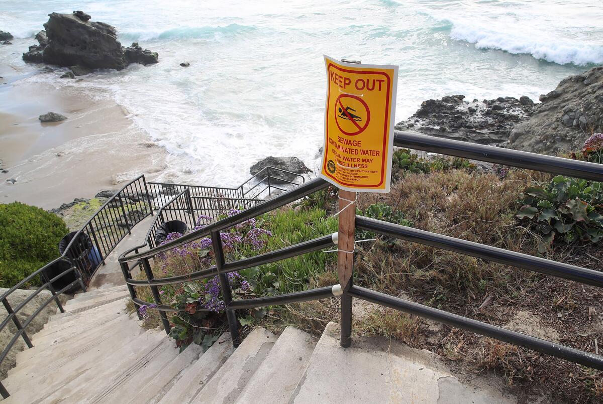 A sign warning beachgoers at the Cress Street stairs after a reported sewage spill in Laguna Beach. 