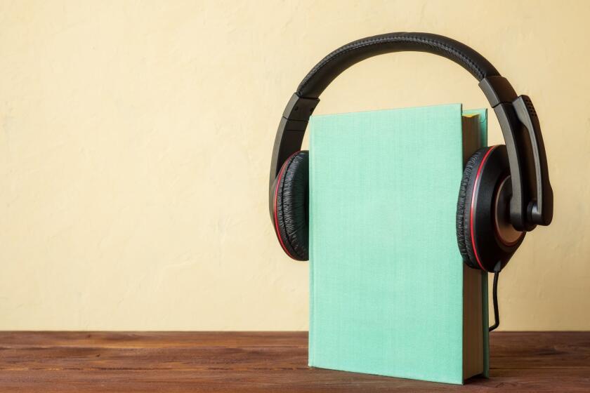 Concept of audiobook. Book on the wooden table with headphones put on them User Upload Caption: . ** OUTS - ELSENT, FPG - OUTS * NM, PH, VA if sourced by CT, LA or MoD **