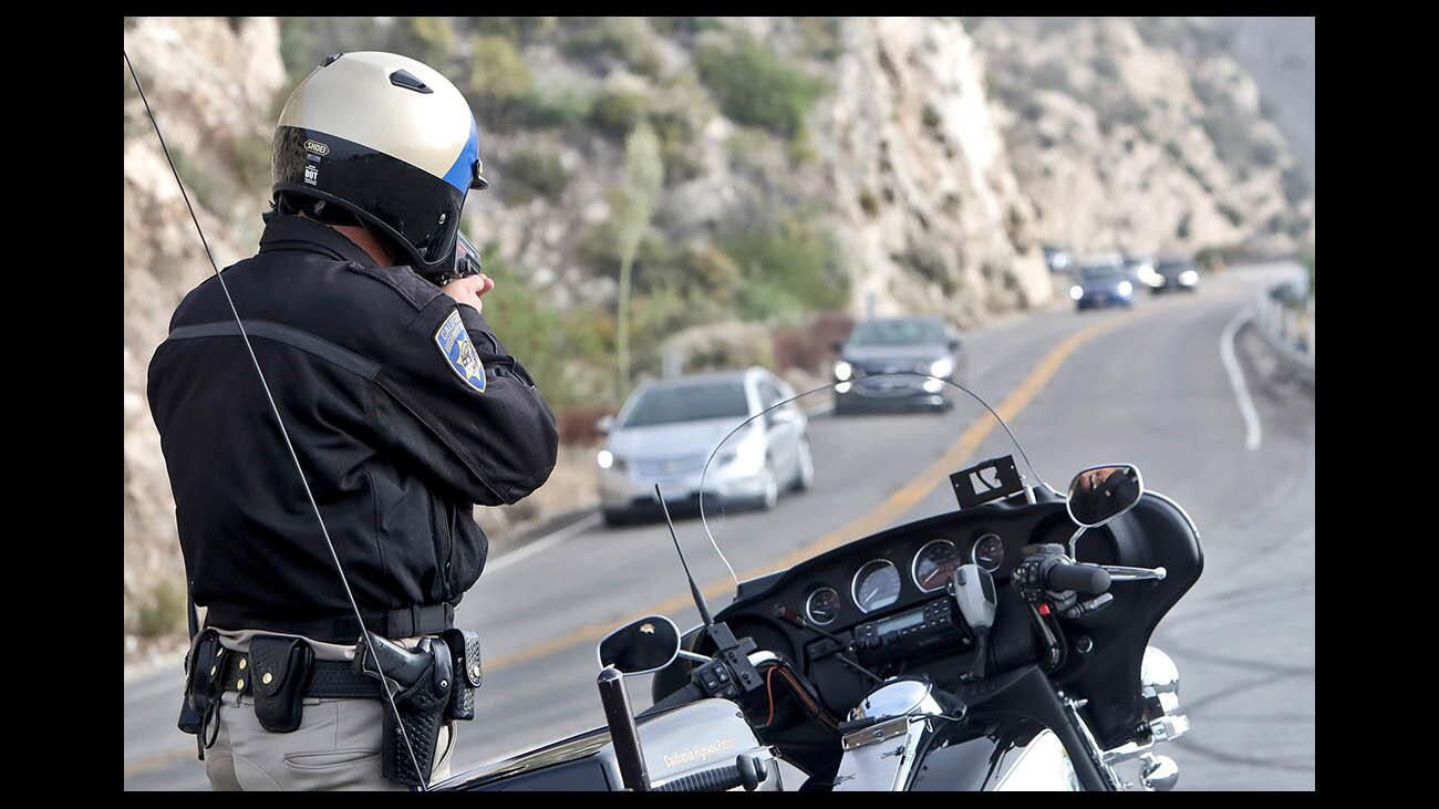 California Highway Patrol officer Cooper checks how fast vehicles are coming down the hill on Angeles Crest Highway a few miles north of La Canada Flintridge, on Friday, June 29, 2018. According to CHP Sgt. Matthew Fountain, the speed enforcement has been done once per week in the same area with vehicles pulled over going much faster than the 40 mph speed limit.