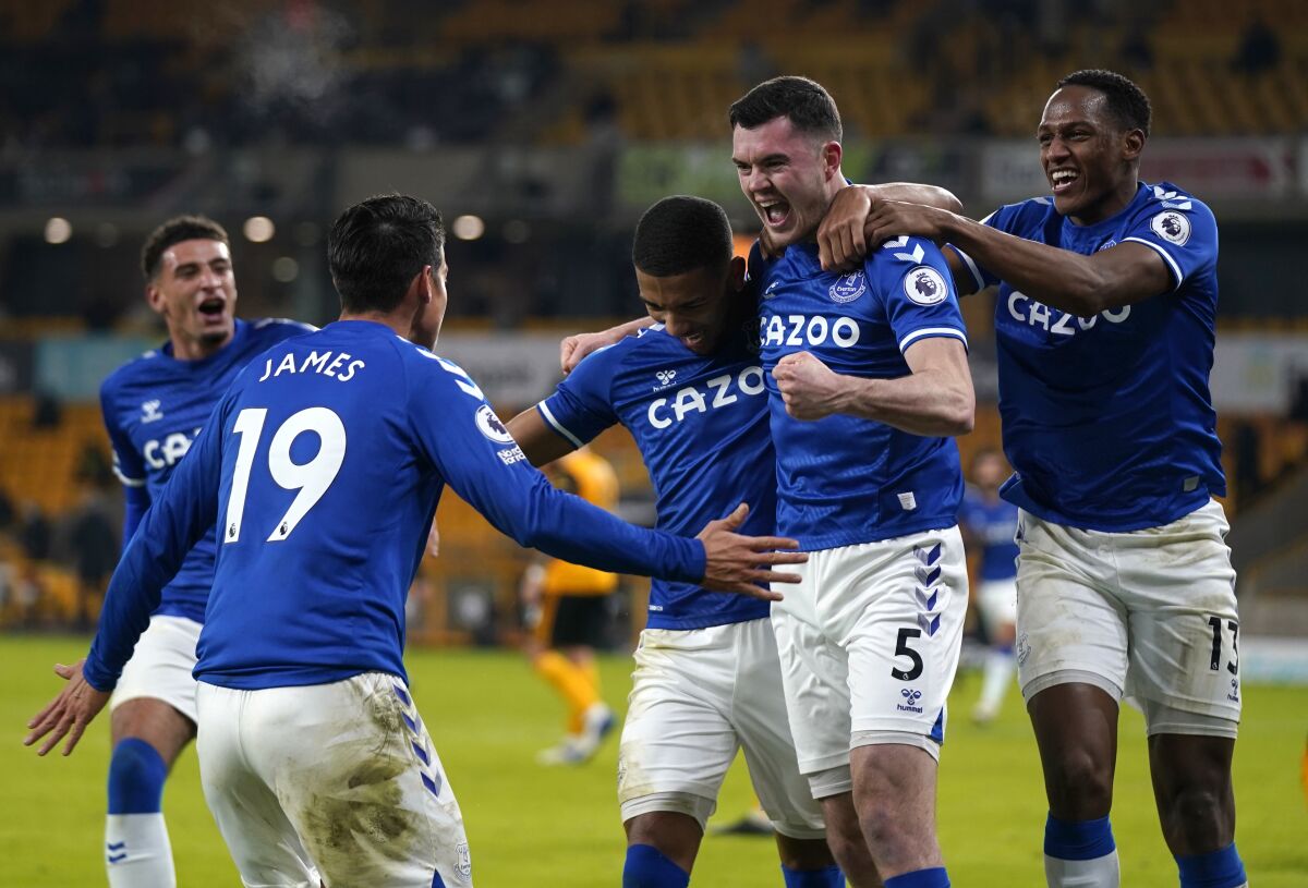 Everton's Michael Keane, second right, celebrates with teammates after scoring his side's second goal during the English Premier League soccer match between Wolverhampton Wanderers and Everton at the Molineux Stadium in Wolverhampton, England, Tuesday, Jan.12, 2021. (Tim Keeton/Pool via AP)