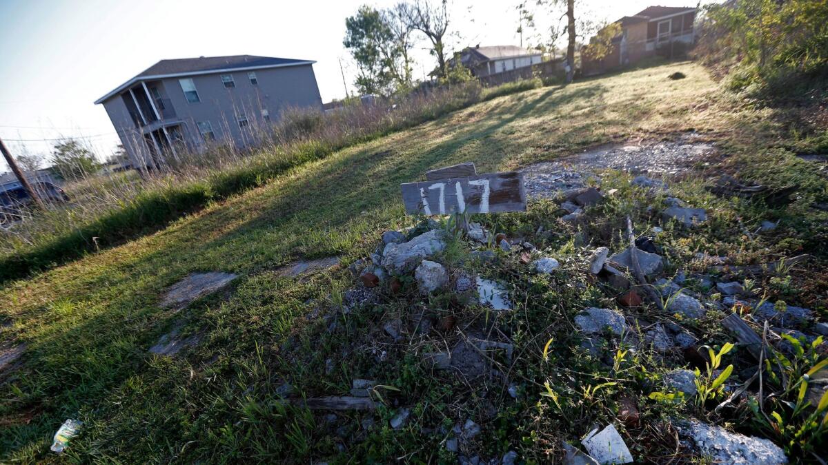 Rubble and an address sign mark an empty lot in the Lower 9th Ward in New Orleans, La. on March 16. The neighborhood of low-to-moderate-income residents was hit hard by Katrina and has struggled to recover.