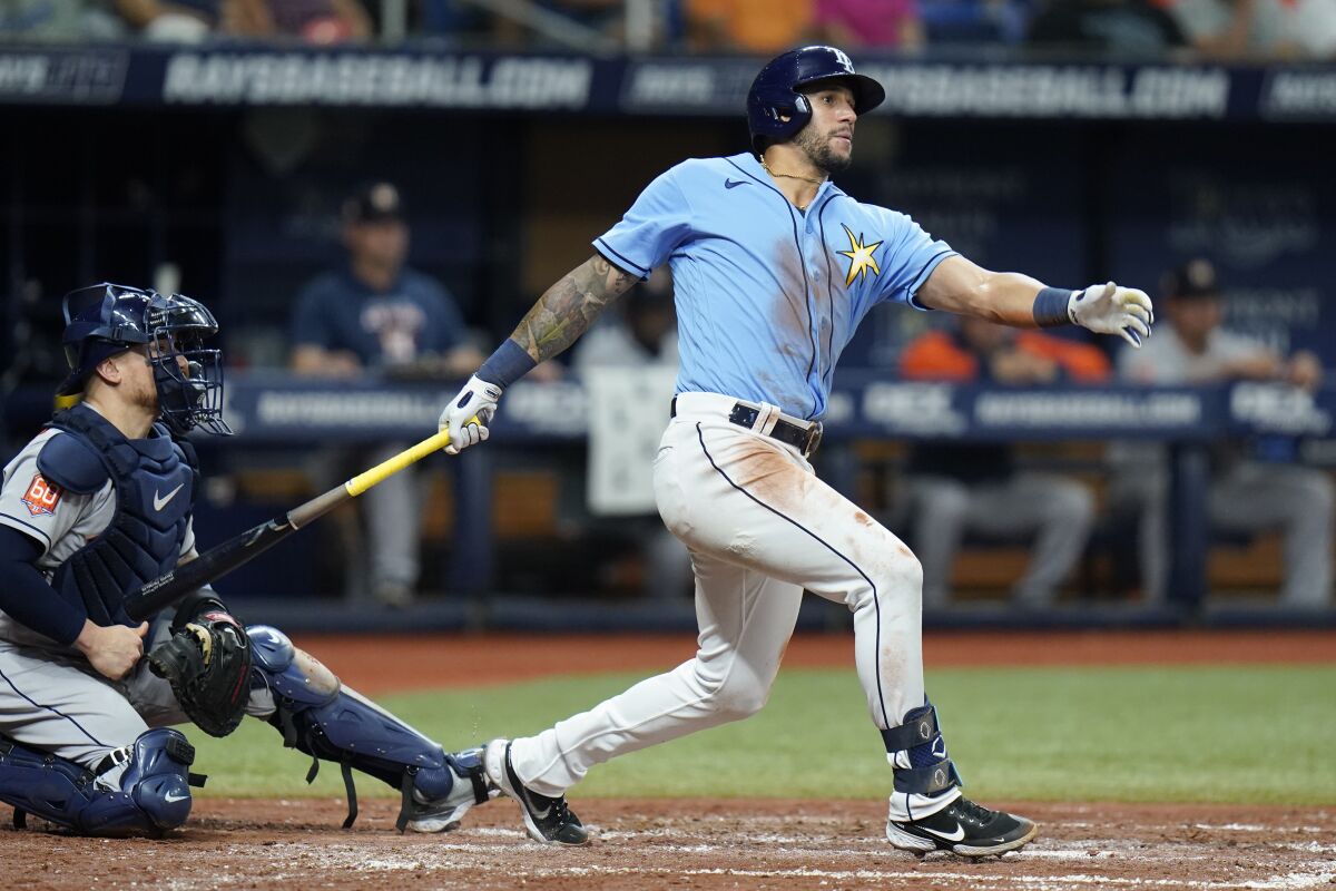 Then-Tampa Bay Rays outfielder David Peralta watches the flight of the ball as he follows through on a swing