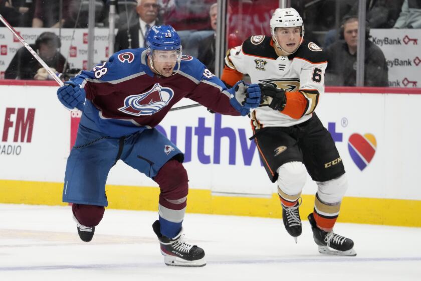 Colorado Avalanche left wing Miles Wood, left, drives past Anaheim Ducks defenseman Tristan Luneau during the third period of an NHL hockey game Tuesday, Dec. 5, 2023, in Denver. (AP Photo/David Zalubowski)