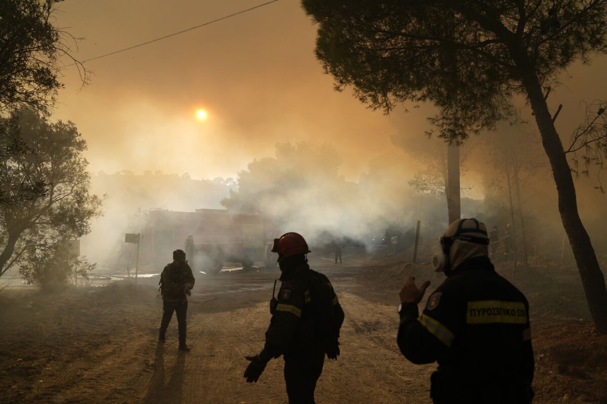 Firefighters operate during a wildfire in Siderina village about 55 kilometers (34 miles) south of Athens, Greece, Monday, Aug. 16, 2021. Two new big wildfires fanned by strong winds erupted Monday in hard-hit Greece, triggering evacuation alerts for villages southeast and northwest of Athens — days after blazes consumed large tracts of forest to the capital's north. (AP Photo/Thanassis Stavrakis)
