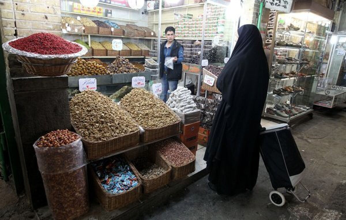 An Iranian woman shops at the Tajrish bazaar in Tehran. The Iranian economy has taken a beating from international sanctions.