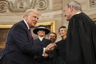 President Trump shakes hands with Chief Justice John Roberts