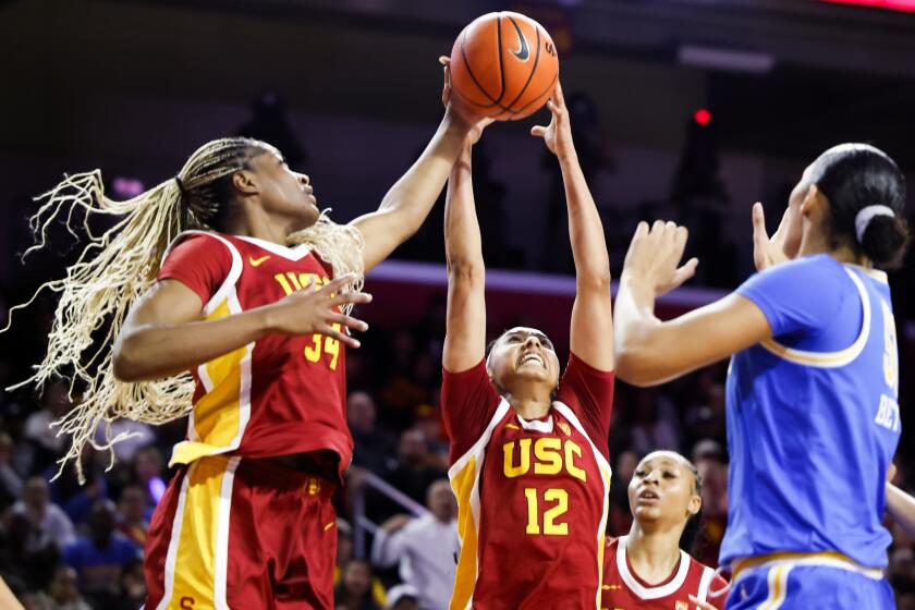 USC center Clarice Akunwafo and guard JuJu Watkins jump for a rebound against UCLA at Galen Center.