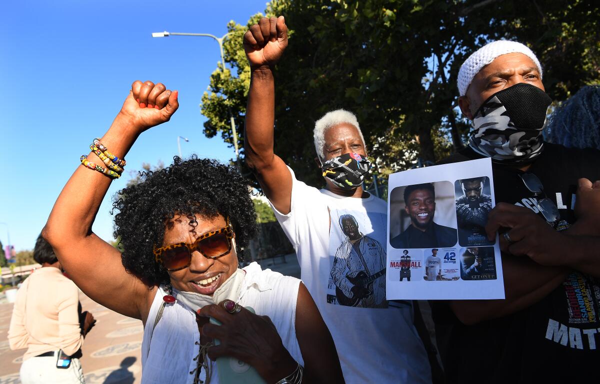 Fans of Chadwick Boseman chant "Wakanda forever" at Leimart Park Saturday.