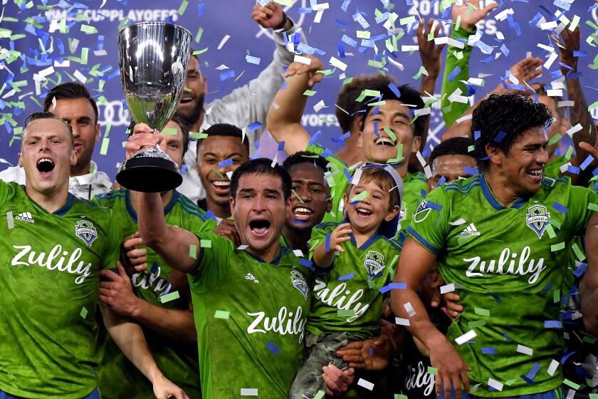 LOS ANGELES, CALIFORNIA - OCTOBER 29: Nicolas Lodeiro #10 of Seattle Sounders hold up the trophy in celebration of a 3-1 win over the Los Angeles FC during the Western Conference finals at Banc of California Stadium on October 29, 2019 in Los Angeles, California. (Photo by Harry How/Getty Images)