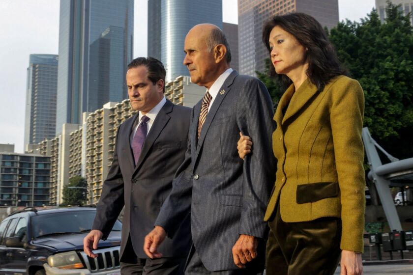Former Los Angeles County Sheriff Lee Baca, center, flanked by his attorney Nathan J. Hochman, left, and wife Carol Chiang, as he arrives at federal court this week for his obstruction of justice trial.
