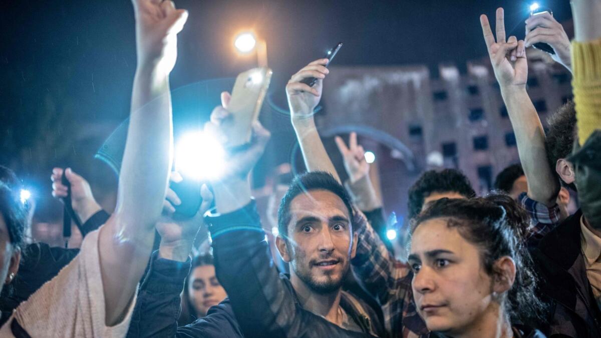 Protesters shine lights from cellphones during a demonstration in Istanbul after authorities annulled the mayoral election result.
