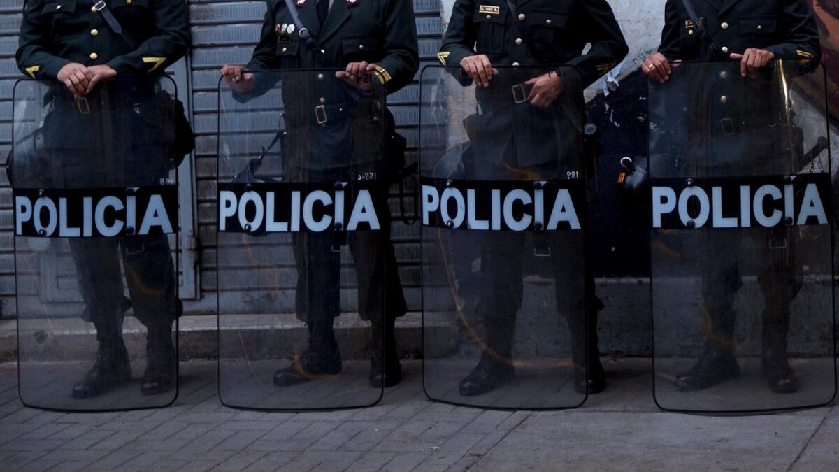 Peruvian police officers stand guard during the inauguration of President Pedro Pablo Kuczynski in Lima in July. Members of the national police are suspected of creating a "death squad" to target and kill criminal suspects.