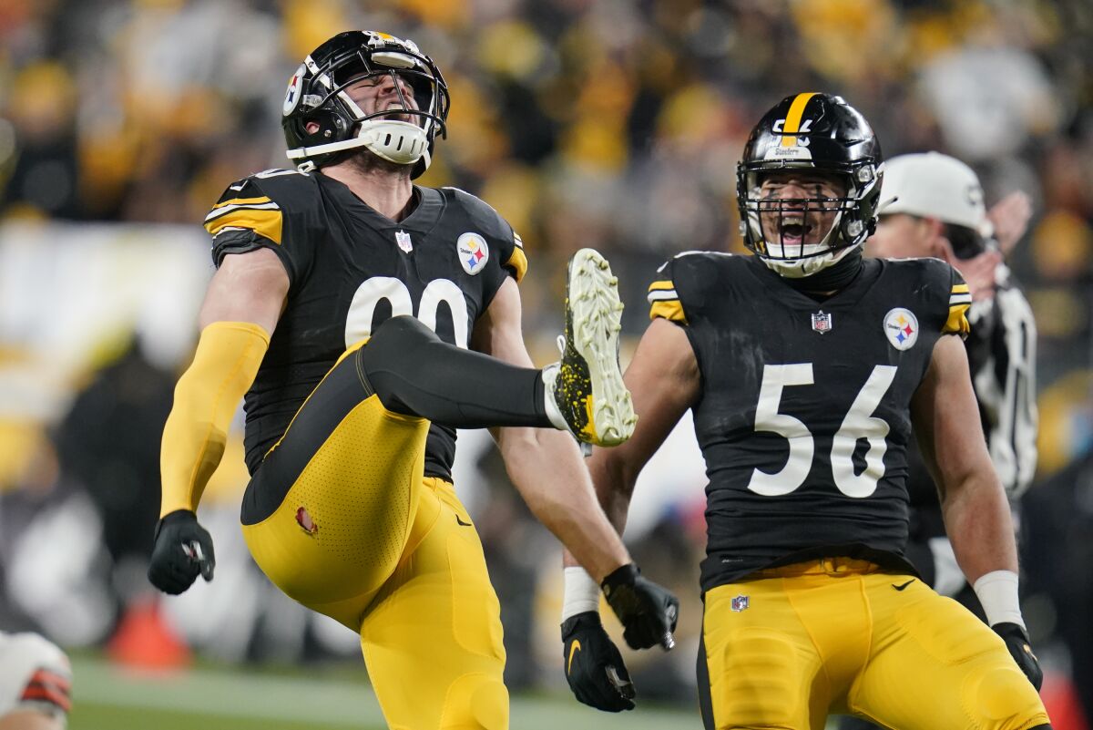Pittsburgh Steelers outside linebacker T.J. Watt (90) celebrates with outside linebacker Alex Highsmith (56) after sacking Cleveland Browns quarterback Baker Mayfield in the first half of an NFL football game, Monday, Jan. 3, 2022, in Pittsburgh. (AP Photo/Gene J. Puskar)