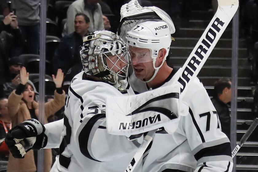ANAHEIM, CALIFORNIA - DECEMBER 12: Jonathan Quick #32 and Jeff Carter #77 of the Los Angeles Kings celebrate their 2-1 victory over the Anaheim Ducks at the Honda Center on December 12, 2019 in Anaheim, California. (Photo by Bruce Bennett/Getty Images)