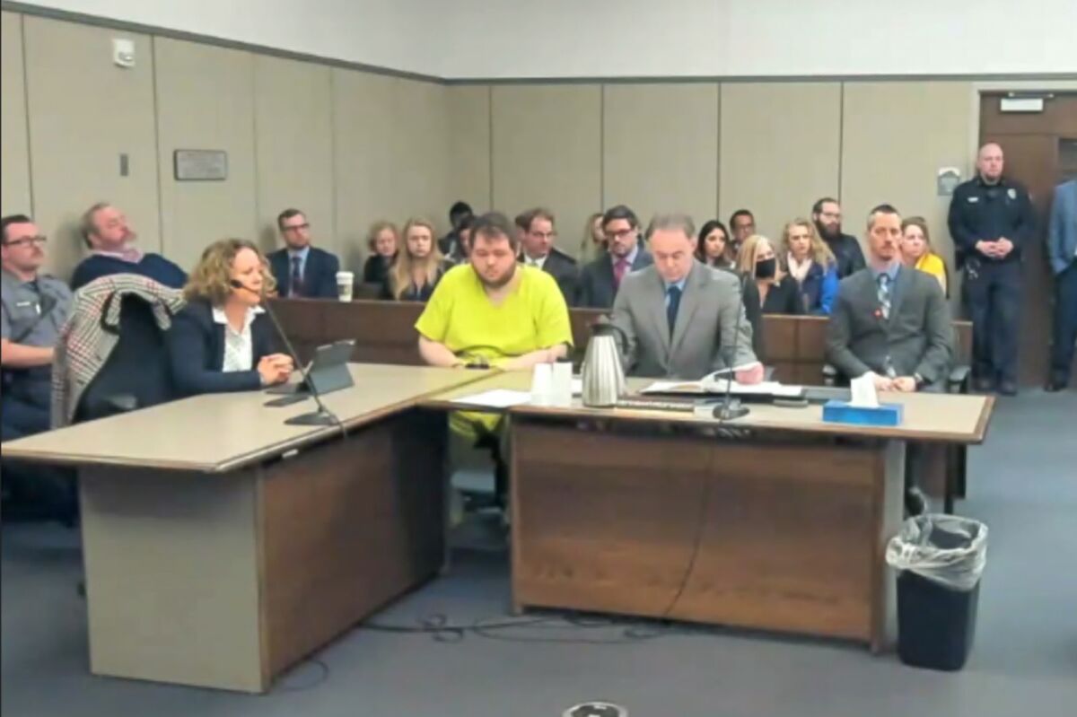 In this image taken from El Paso County District Court video, Anderson Lee Aldrich, 22, center, sits during a court appearance in Colorado Springs, Colo., Tuesday, Dec. Nov. 6, 2022. Aldrich, the suspect accused of entering a Colorado gay nightclub clad in body armor and opening fire with an AR-15-style rifle, killing five people and wounding 17 others, was charged by prosecutors Tuesday with 305 criminal counts including hate crimes and murder. (El Paso County District Court via AP)