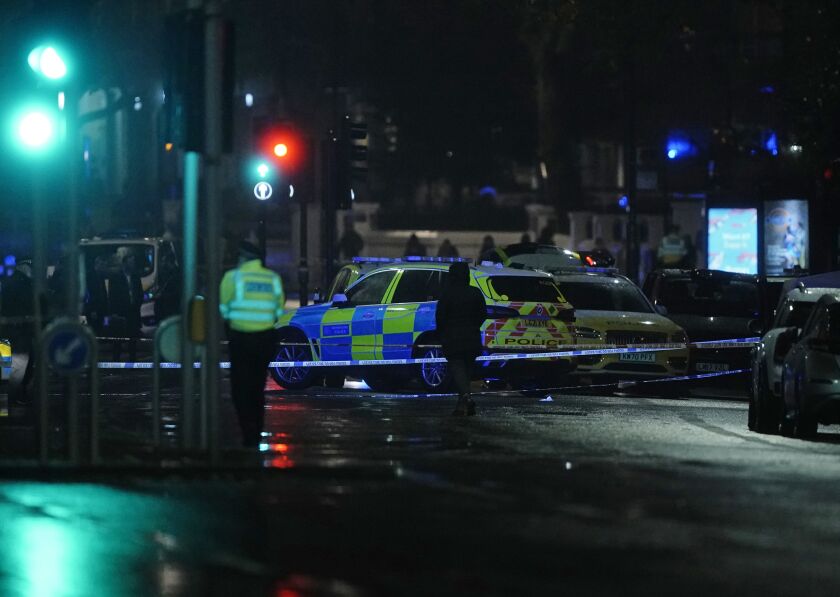 Police attend the scene near Kensington High Street in London, Saturday Dec. 11, 2021, where British police say a man has been shot dead during a confrontation with firearms officers near the Kensington Palace royal residence. (Aaron Chown/PA via AP)