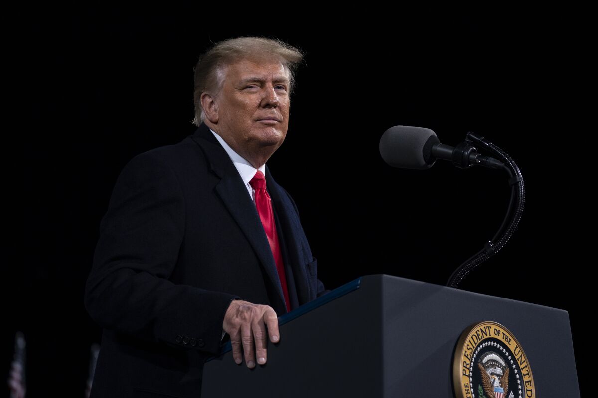 A man stands behind a lectern.