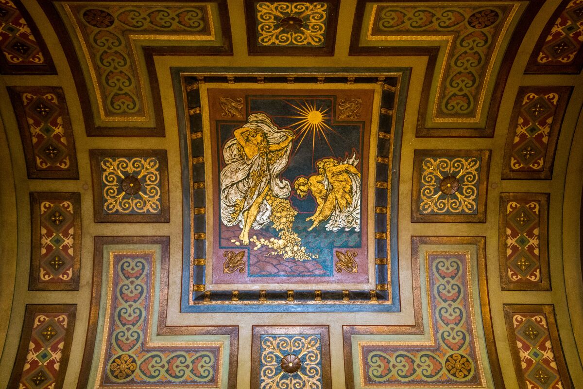 A mythical scene decorates an ornate barrel ceiling.