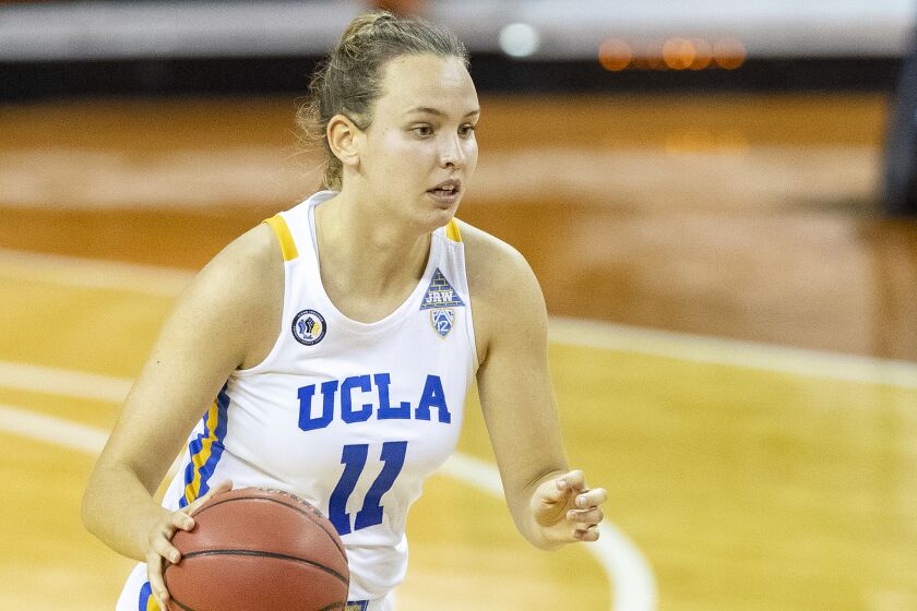 UCLA forward Emily Bessoir takes the ball down court against Wyoming.