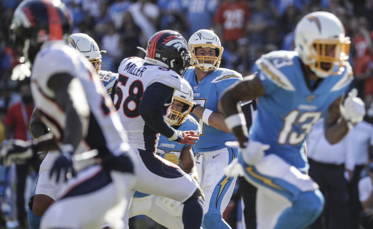 Chargers' Philip Rivers drops back to pass in Sunday's game against the Broncos.