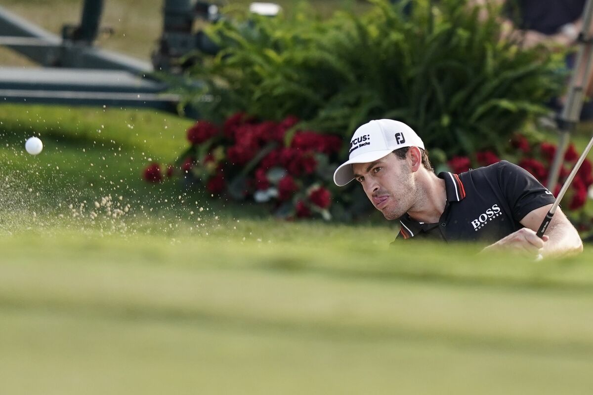 Patrick Cantlay hits out of a bunker on the 18th hole during the third round of the Tour Championship golf tournament Saturday, Sept. 4, 2021, at East Lake Golf Club in Atlanta. (AP Photo/Brynn Anderson)