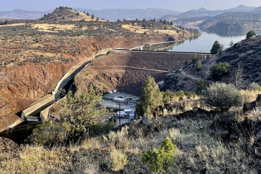 The Iron Gate Dam is seen in Hornbrook, Calif., Sept. 17, 2023. The dam is one of a series of four dams along the Klamath River which are part of the largest dam removal project in United States history. Now underway along the Oregon border, the process won't conclude until the end of next year with the help of heavy machinery and explosives. (AP Photo/Haven Daley)