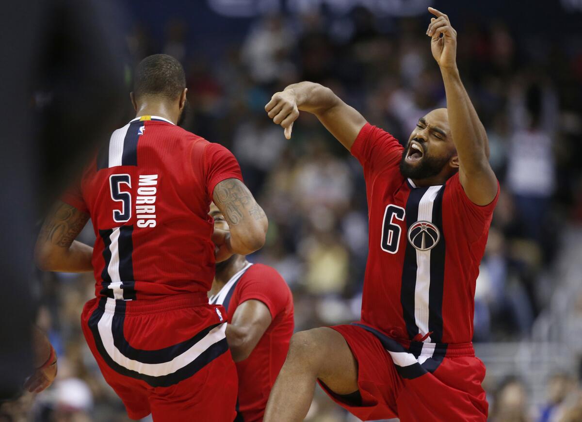 Wizards forward Markieff Morris (5) and guard Alan Anderson (6) celebrate after Morris dunked against the Knicks on Mar. 19.