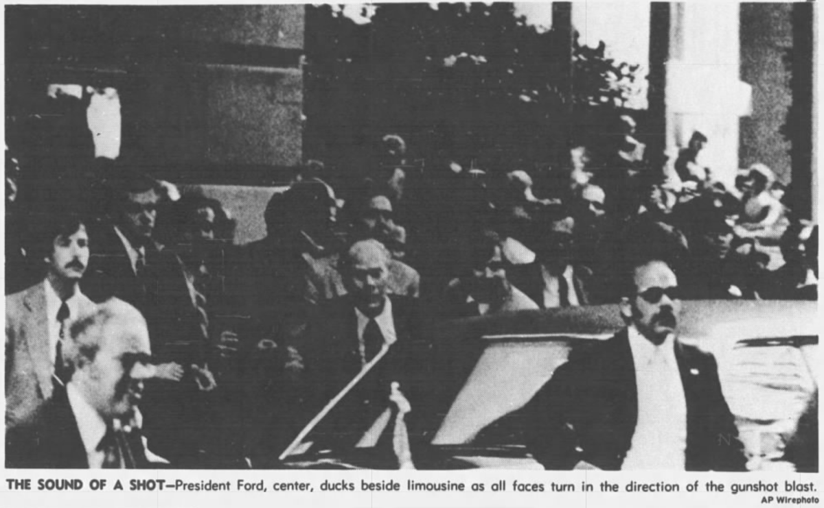 A black-and-white newspaper clipping of a crowd of people outside a limo. 