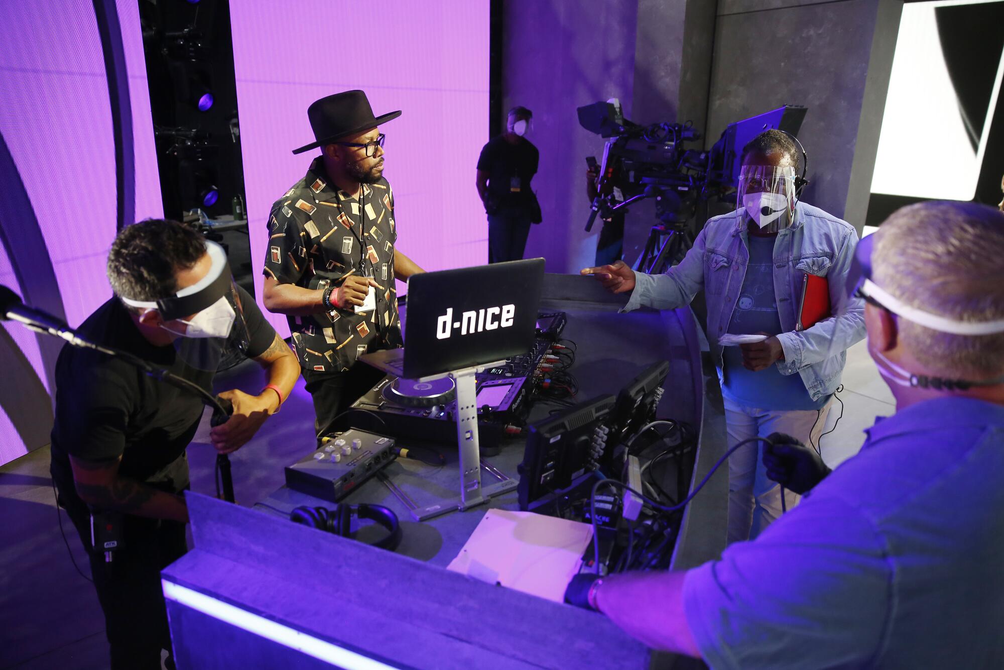 D-Nice, known as Derrick Jones, a DJ, rapper and producer, sets up onstage during rehearsals.