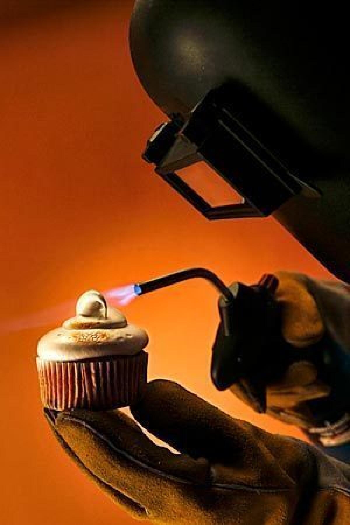 Food cover shot for a story about using a blowtorch in the kitchen. We were looking for a somewhat humorous approach to the shot, taking the theatrics of kitchen pyrotechnics one step further by adding a welder's mask and gloves to an otherwise simple shot of bruleeing a s'mores cupcake. Click here for the story.