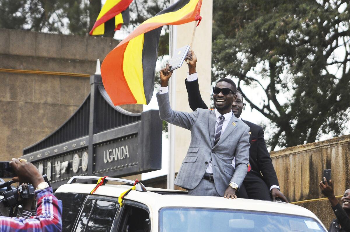 Bobi Wine, center, gestures to supporters shortly after being sworn in as a member of Parliament in Kampala, Uganda, in 2017. The "ghetto child" is a new lawmaker who urges his countrymen to stand up against what he calls a failing government.