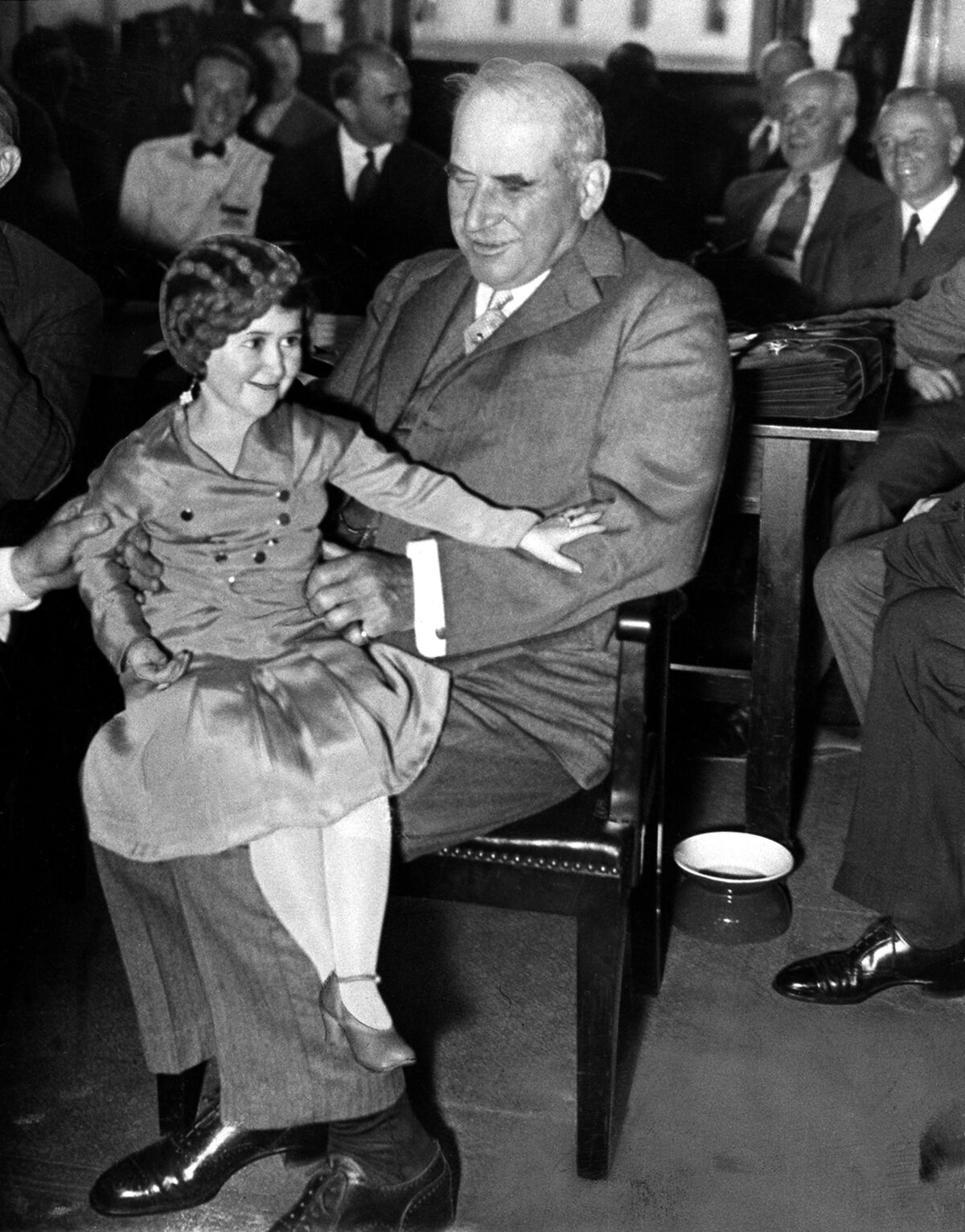 J.P. "Jack" Morgan Jr. holds performer Lya Graf on his knee during the Pecora hearings in 1933.