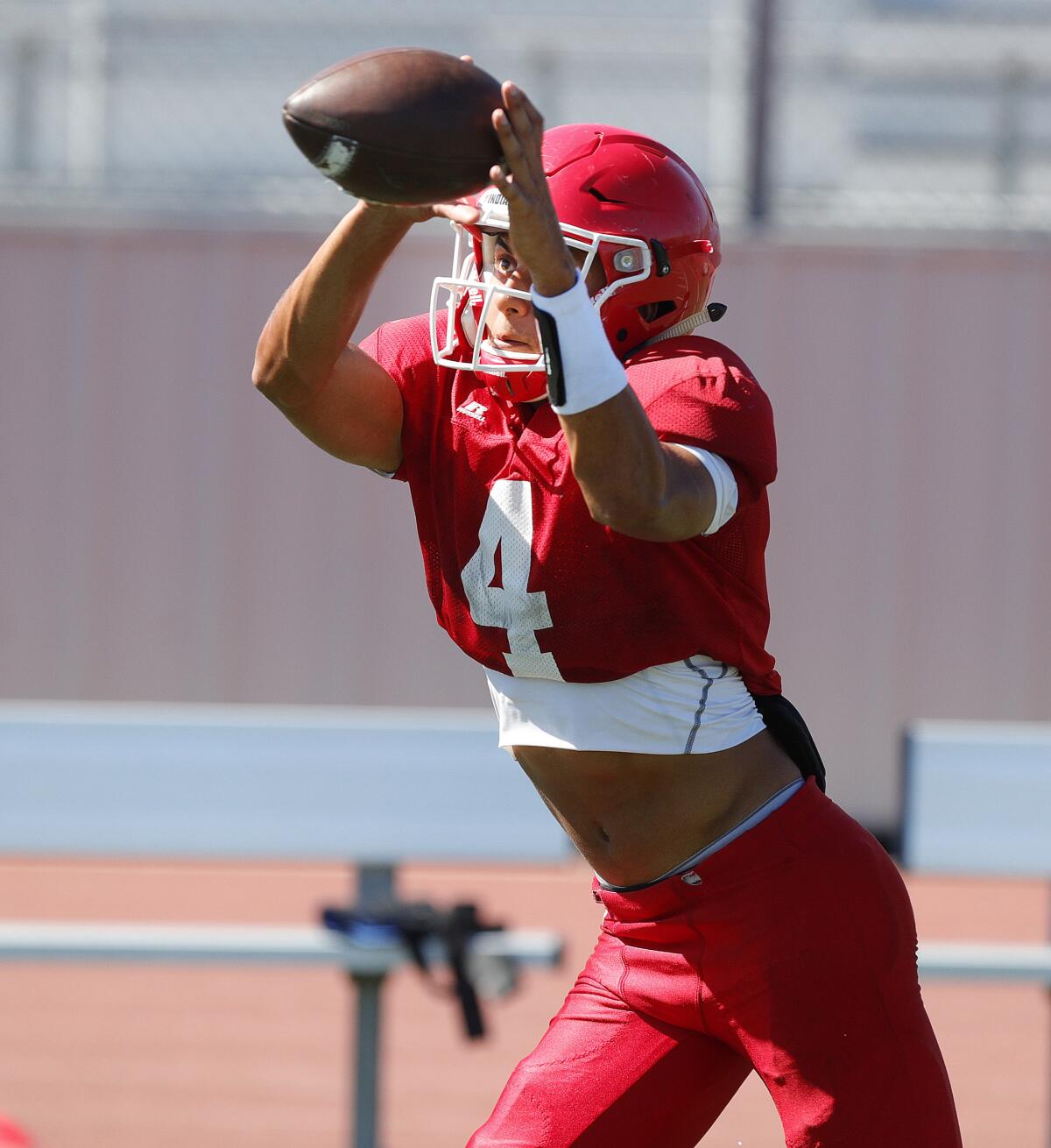 Burroughs' Ellington Simmons reaches up for a catch during a drill at football practice at Burroughs High School in Burbank on Tuesday, August 13, 2019.
