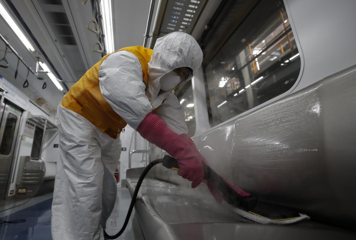 A worker disinfects a subway car in Seoul on Wednesday.