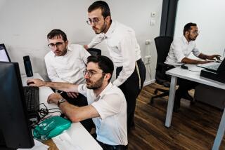 BNEI BRAK, ISRAEL -- NOVEMBER 14, 2023: From left, Uri Yaffe, Itzik Shapira, Uriel Ringel, work together alongside other students from Orthodox Jewish communities to learn how to code and program at JBH, a school that trains Haredi men to become programmers and software developers at firms like Citibank and Mobileye, in Bnei Brak, Israel, Tuesday, Nov. 14, 2023. This push to encourage them to join IsraelOs vibrant technology industry D beyond the bounds of tradition comes when ultra-Orthodox Jews are resented by a larger secular society for religious school subsidies and other benefits, including exemption from compulsory military service for Torah students. Those tensions led to mass street protests last year as far-right nationalist and religious parties became prominent voices in Prime Minister Benjamin NetanyahuOs coalition government. Many Israelis regard the power that religious parties wield as a threat to the countryOs democratic identity. (MARCUS YAM / LOS ANGELES TIMES)