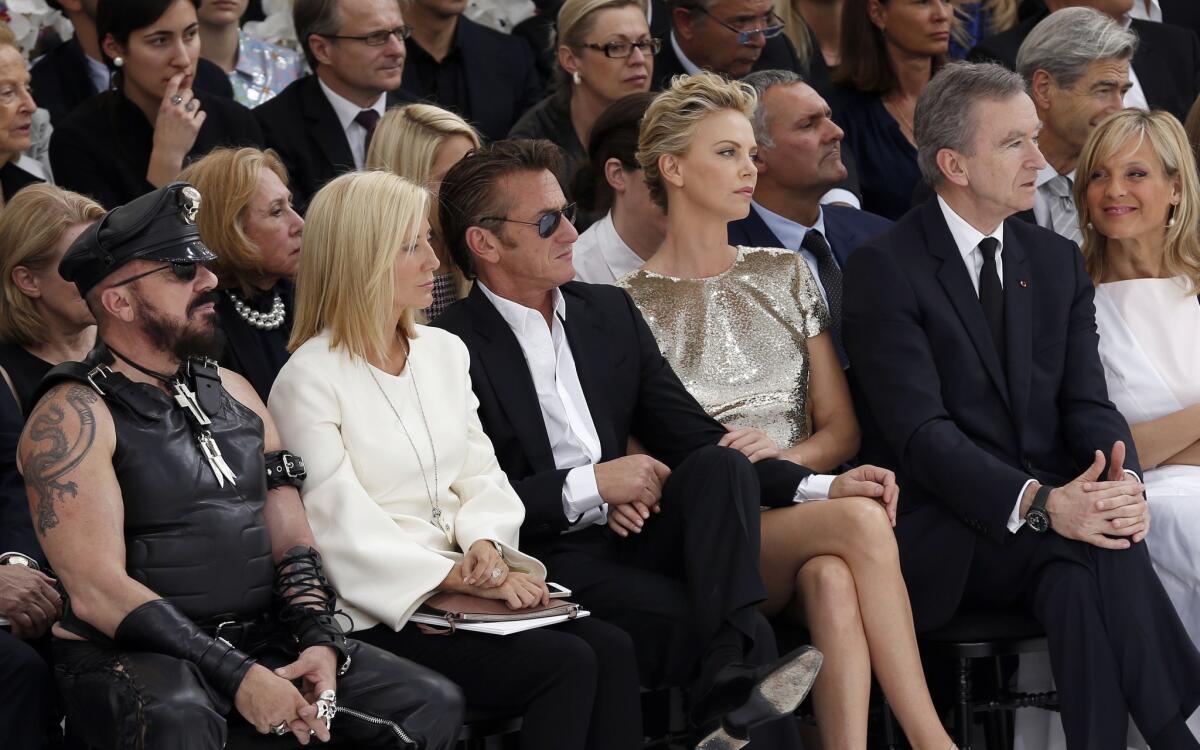 Sean Penn and Charlize Theron, third and fourth from left, attend Christian Dior's 2014/2015 haute couture show on July 7 in Paris.