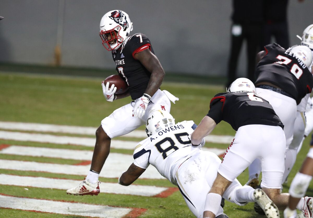 North Carolina State running back Zonovan 'Bam' Knight (7) scores on a 5-yard touchdown run against Georgia Tech during the first half of an NCAA college football game in Raleigh, N.C., Saturday, Dec. 5, 2020. (Ethan Hyman/The News & Observer via AP, Pool)