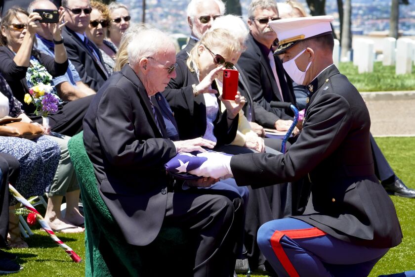 San Diego, CA - June 08: On Tuesday, June 8, 2021 in San Diego, CA., at Fort Rosecrans National Cemetery, Lt. Col Christopher Benson presents the flag that covered U.S. Marine Corps, PFC John Middleswart casket, Edward Brown during the full military honors ceremony. (Nelvin C. Cepeda / The San Diego Union-Tribune)