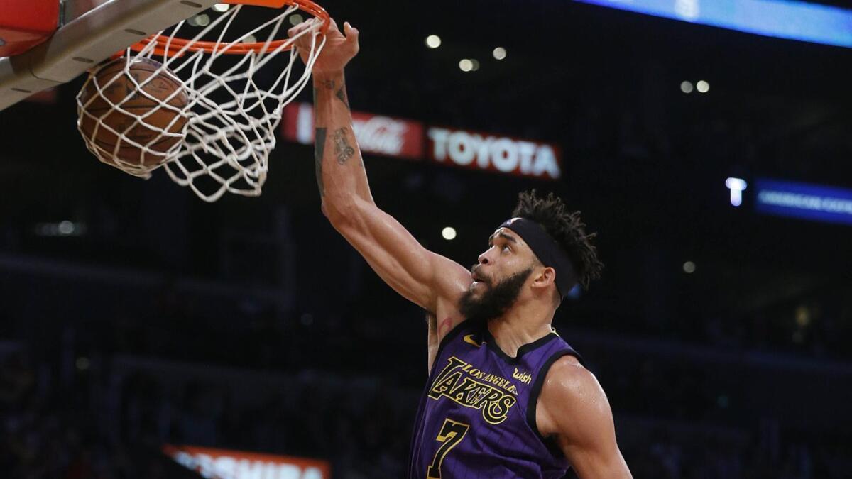 Lakers center JaVale McGee slam dunks the ball during the second half against the Brooklyn Nets at Staples Center on Friday.