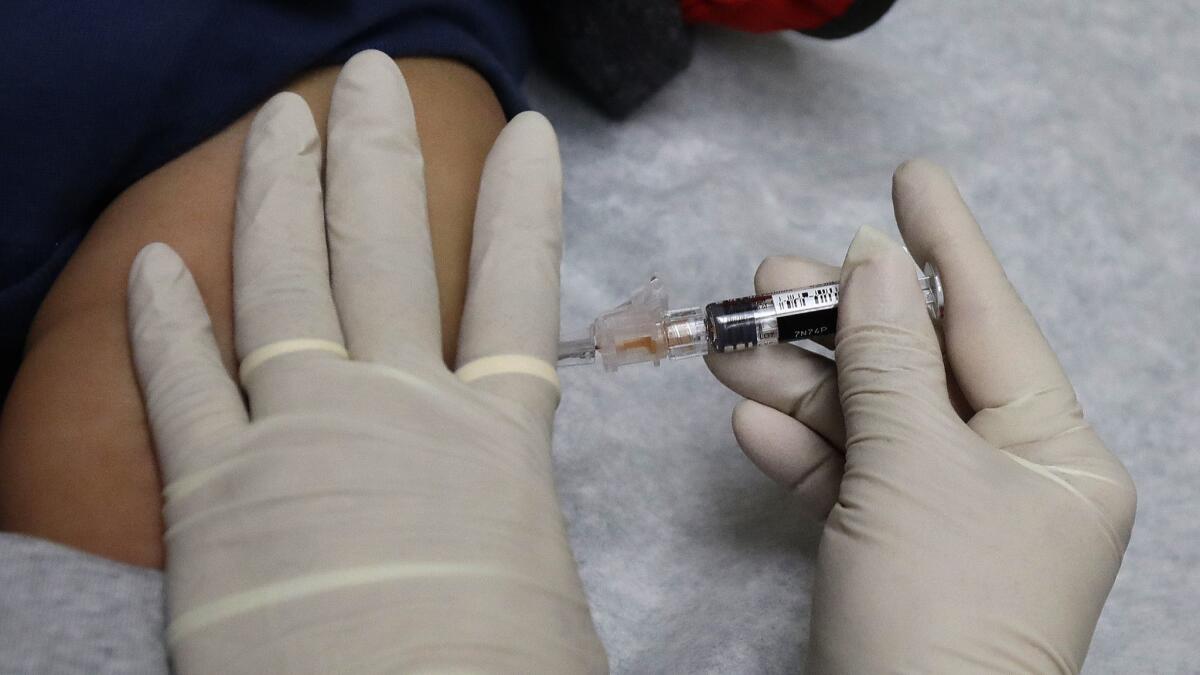 A patient receives a flu shot.