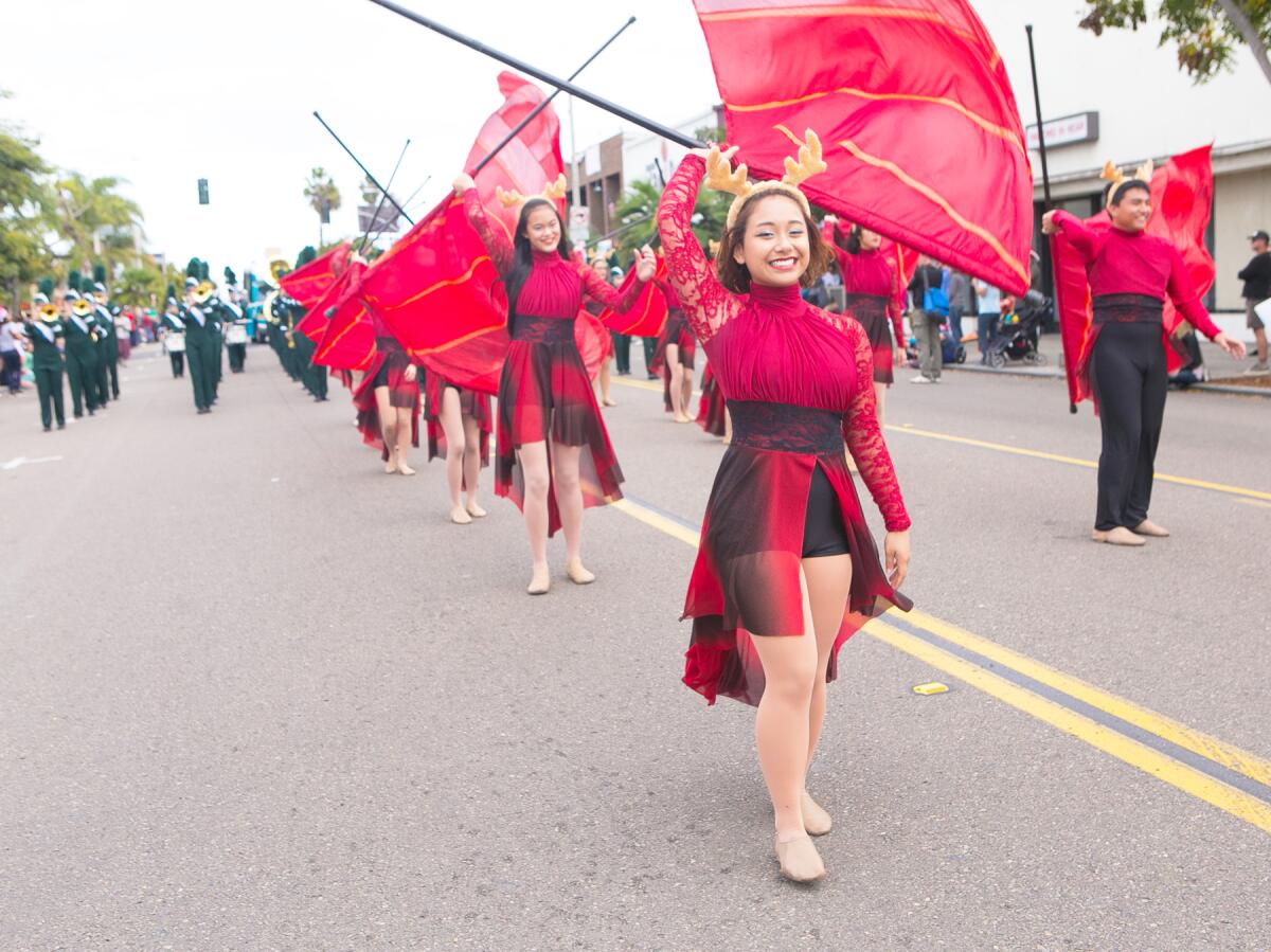 A high school color guard performing at a previous Pacific Beach Holiday Parade.