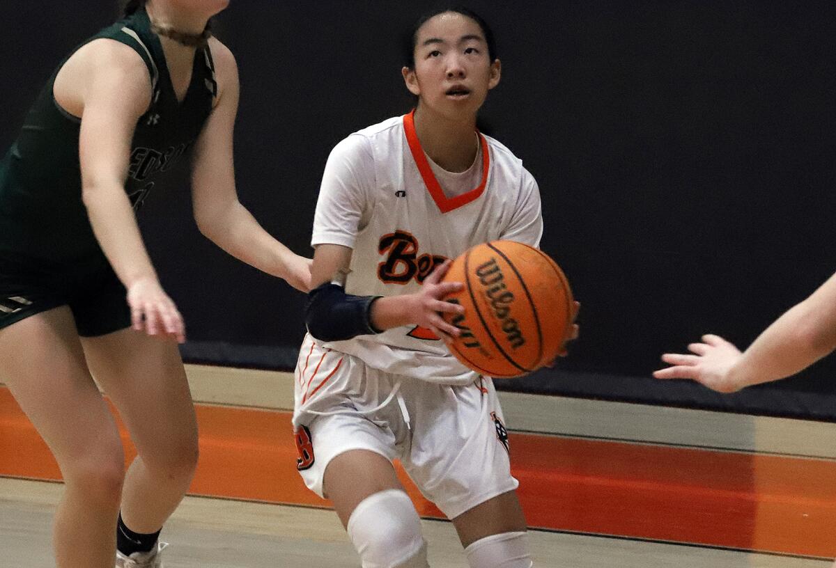 Huntington Beach's Emma Miyai (2) shoots against Edison in a Sunset Conference crossover girls' basketball game.