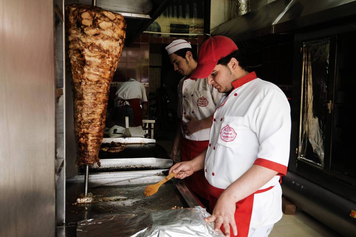 Refugees from Syria work at a restaurant on the outskirts of Cairo. As of July 8, more than 70,000 Syrians had registered with the Egypt office of the United Nations refugee agency.