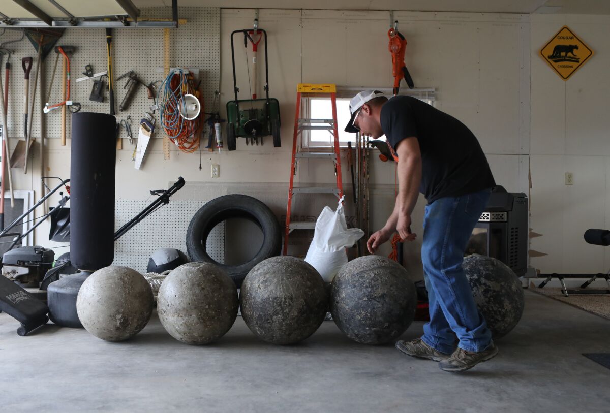Cancer survivor Charley Butler is training for strongman competitions at his Sidney, Mont., home.